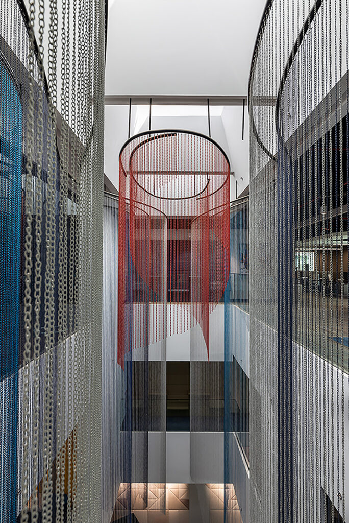 Atrium adorned with triple-height metal curtains