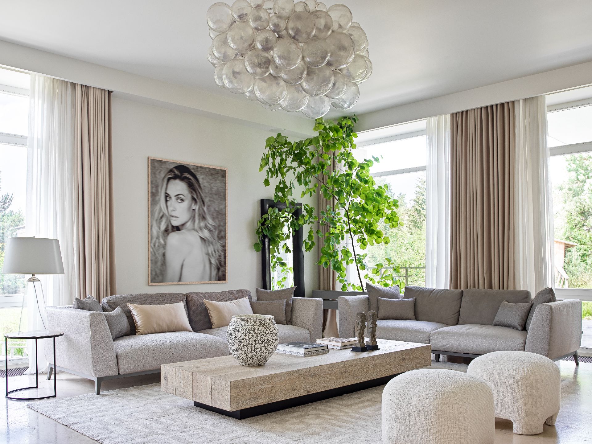 Flou sofas, Altagamma interior coffee table, Portrait by Inho Co. Oly Studio chandelier. Crate & Barrel lamp and coffee table. Loffilab poufs. Marina Akilova vase. 