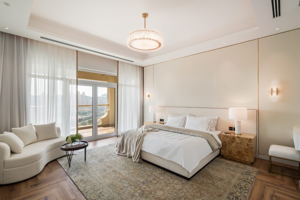 This penthouse comes with three bedrooms. The master bedroom features a neutral, warm tone palette that establishes a cozy, and calm atmosphere.