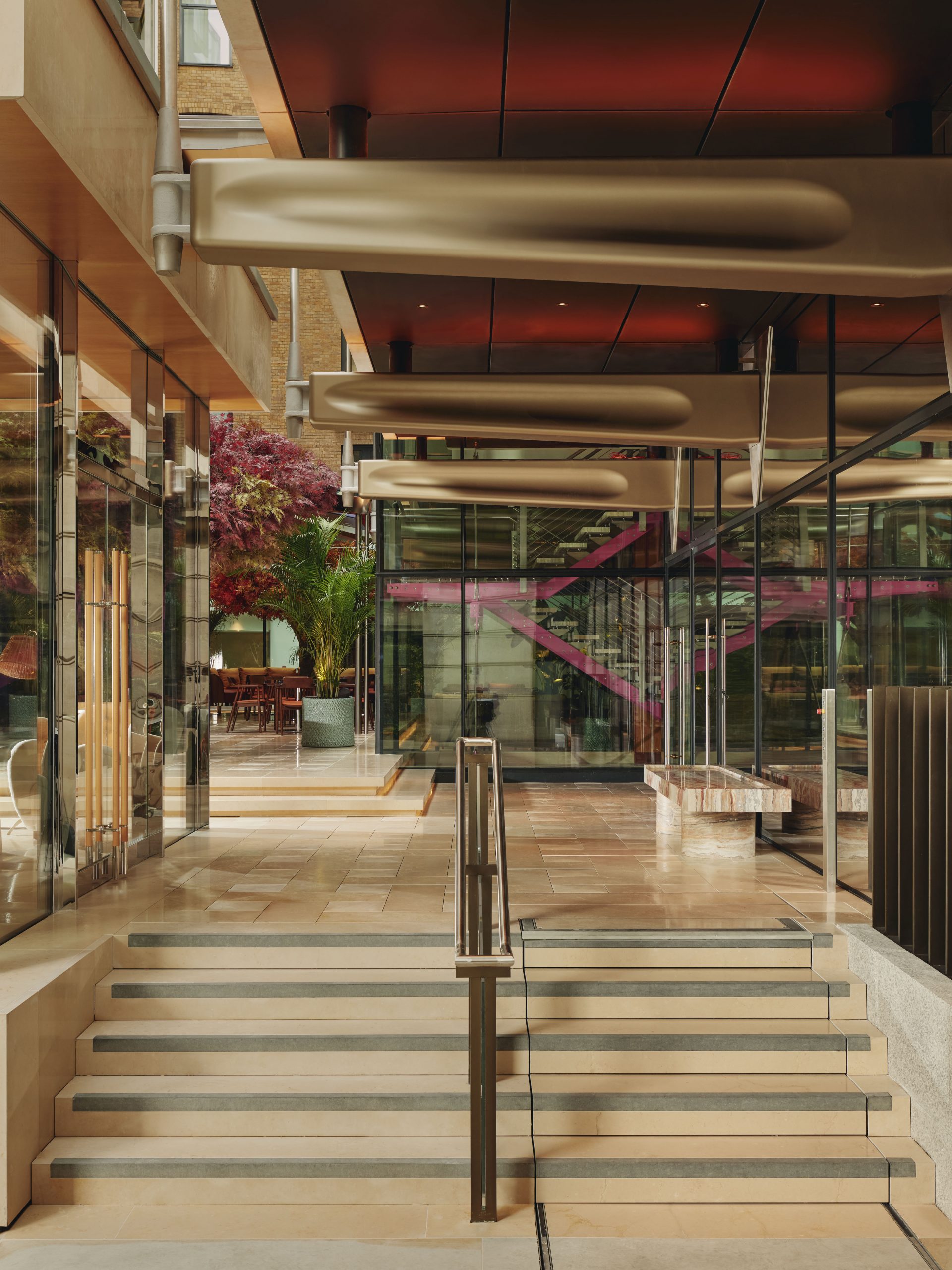 The entrance to the Emory lobby showcasing the stairwell that pays homage to Richard Rogers with shades of the color Richard Rogers Pink