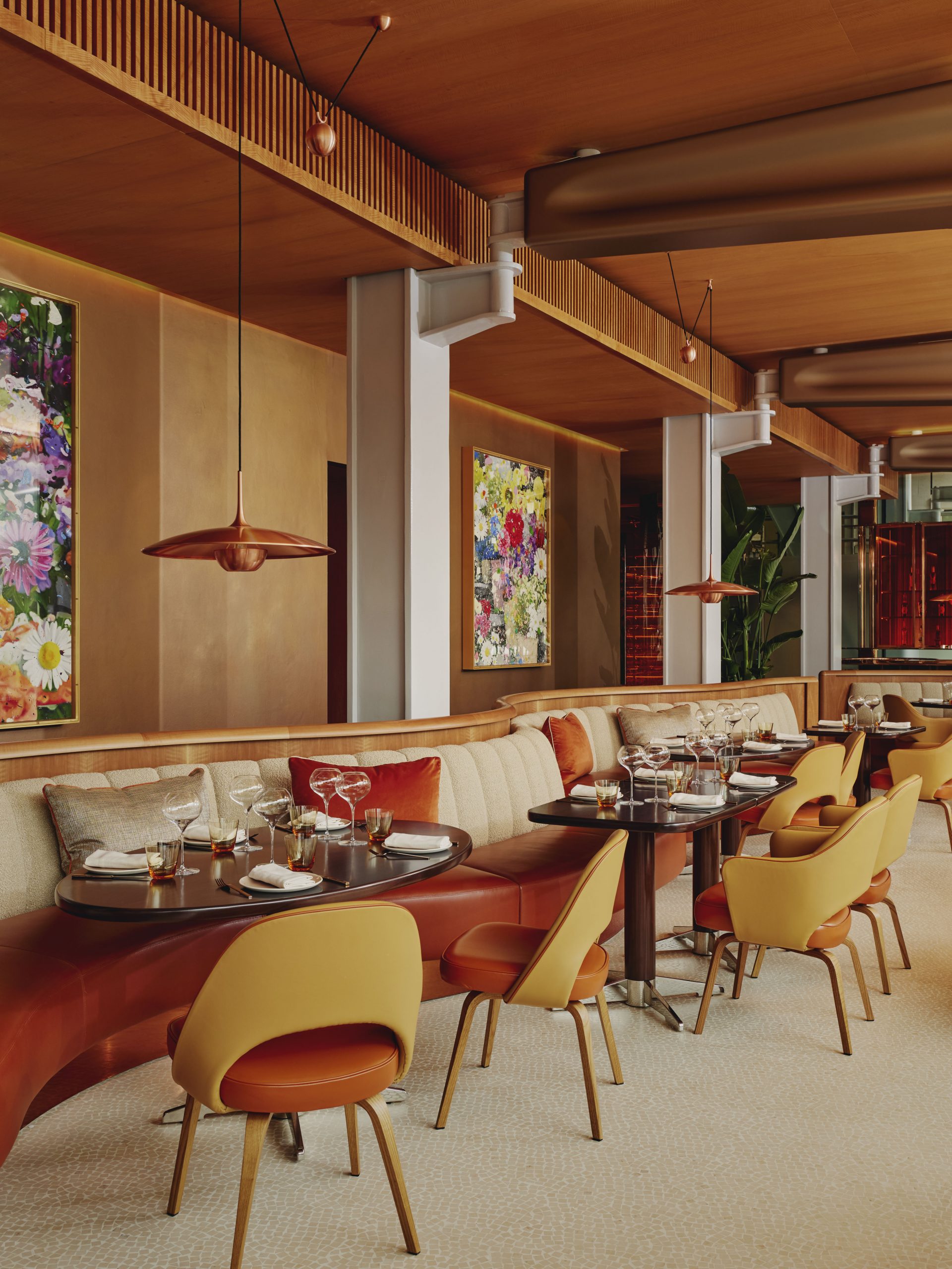 The ABC kitchen dining area, designed by Rémi Tessier. Decorated in warm tones and Damien Hirst artwork