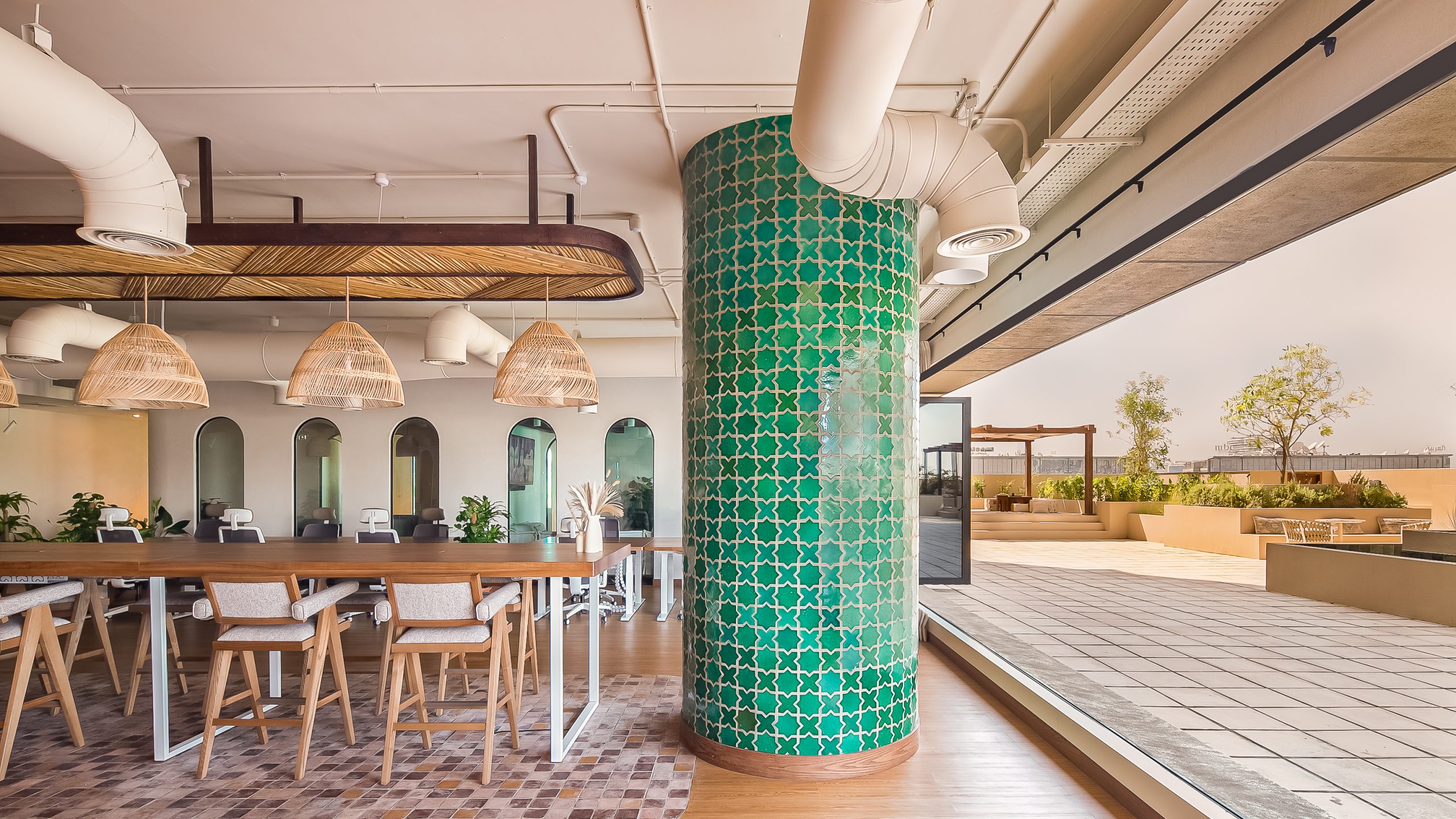 green artisan tiles and textured finishes in the main Beyond One's office