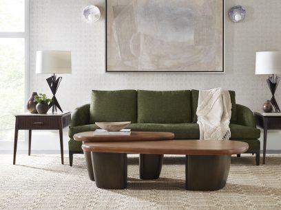 a green sofa with a warm toned centerpiece