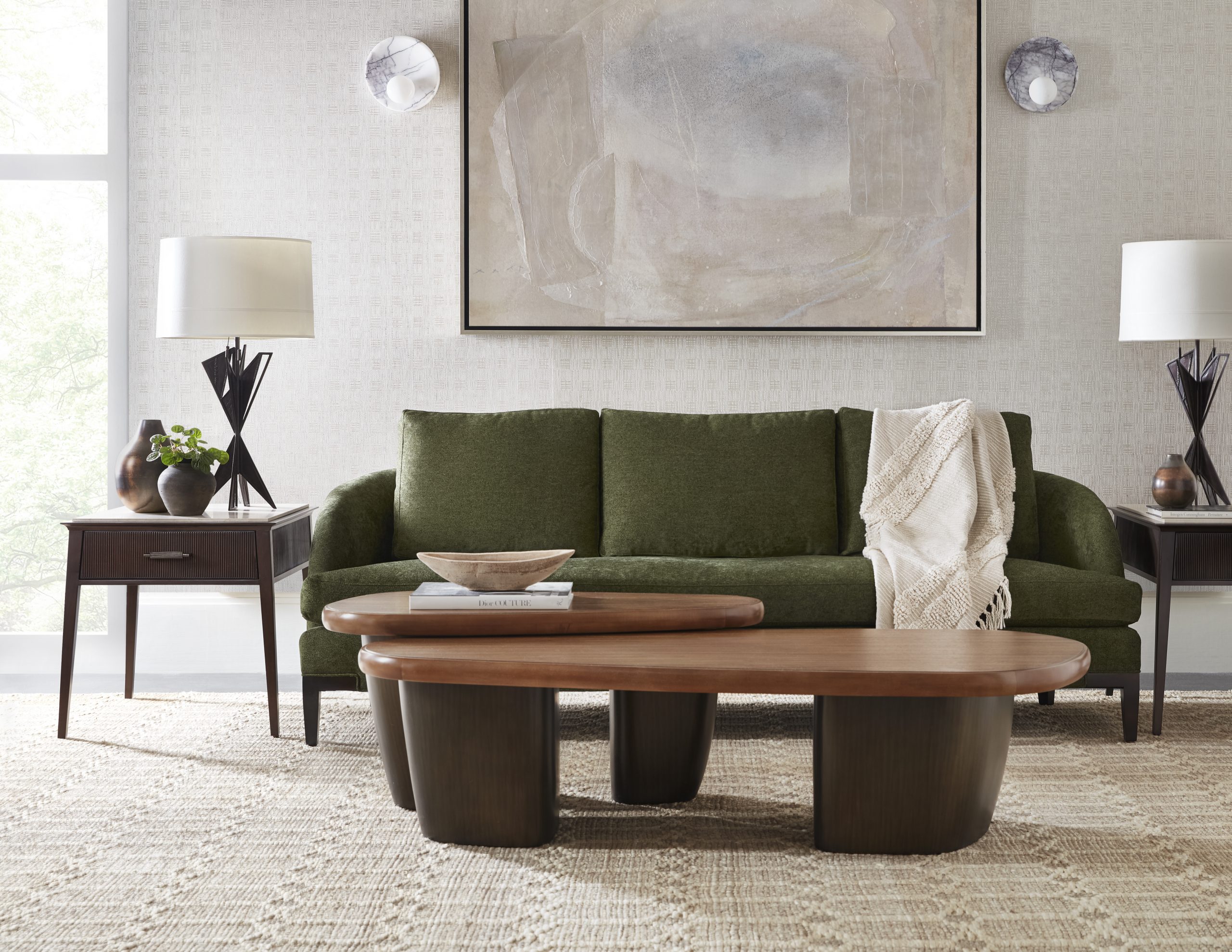 a green sofa with a warm toned centerpiece