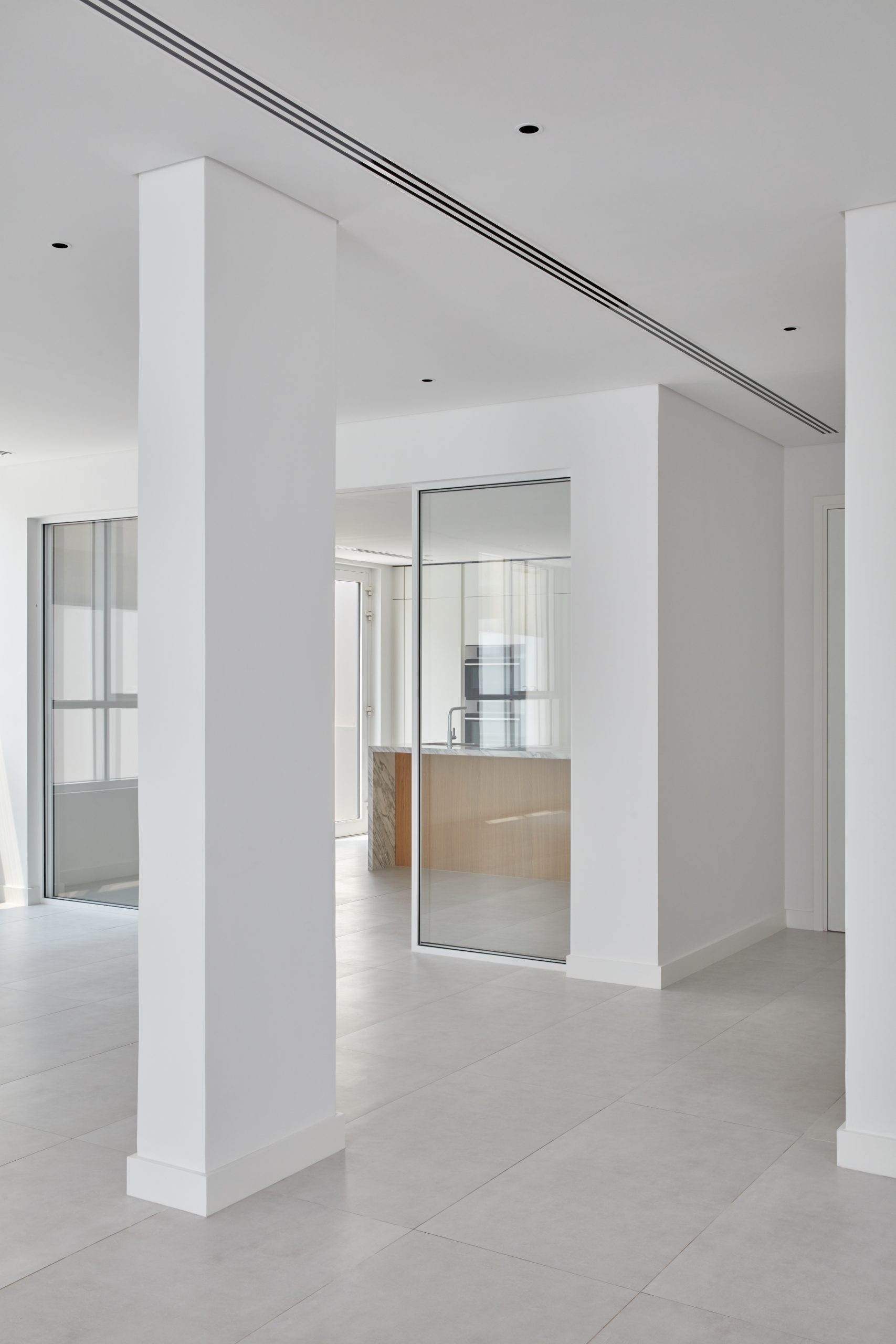 White interiors with glass doors and a square pillar 