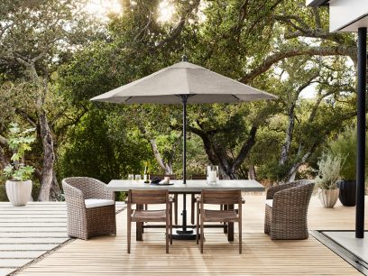 A table and chairs under an umbrella on a deck