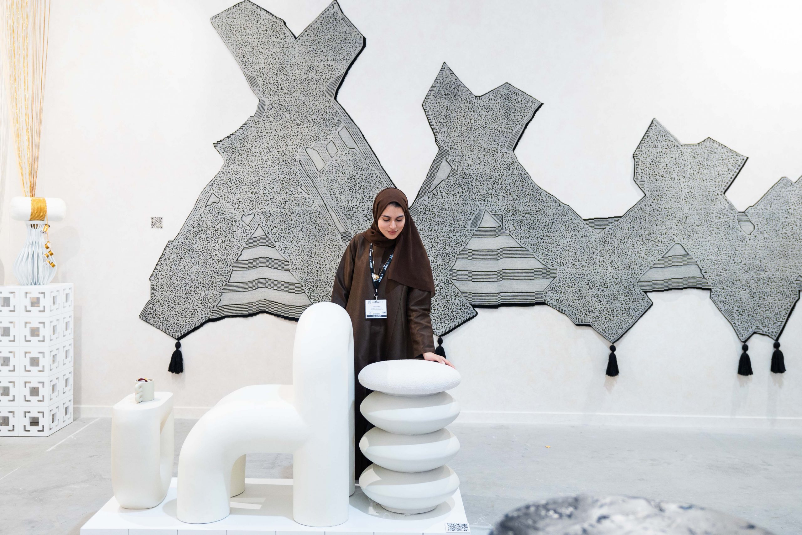 A woman interacting with designs at Dubai Design Week 2024, Editions