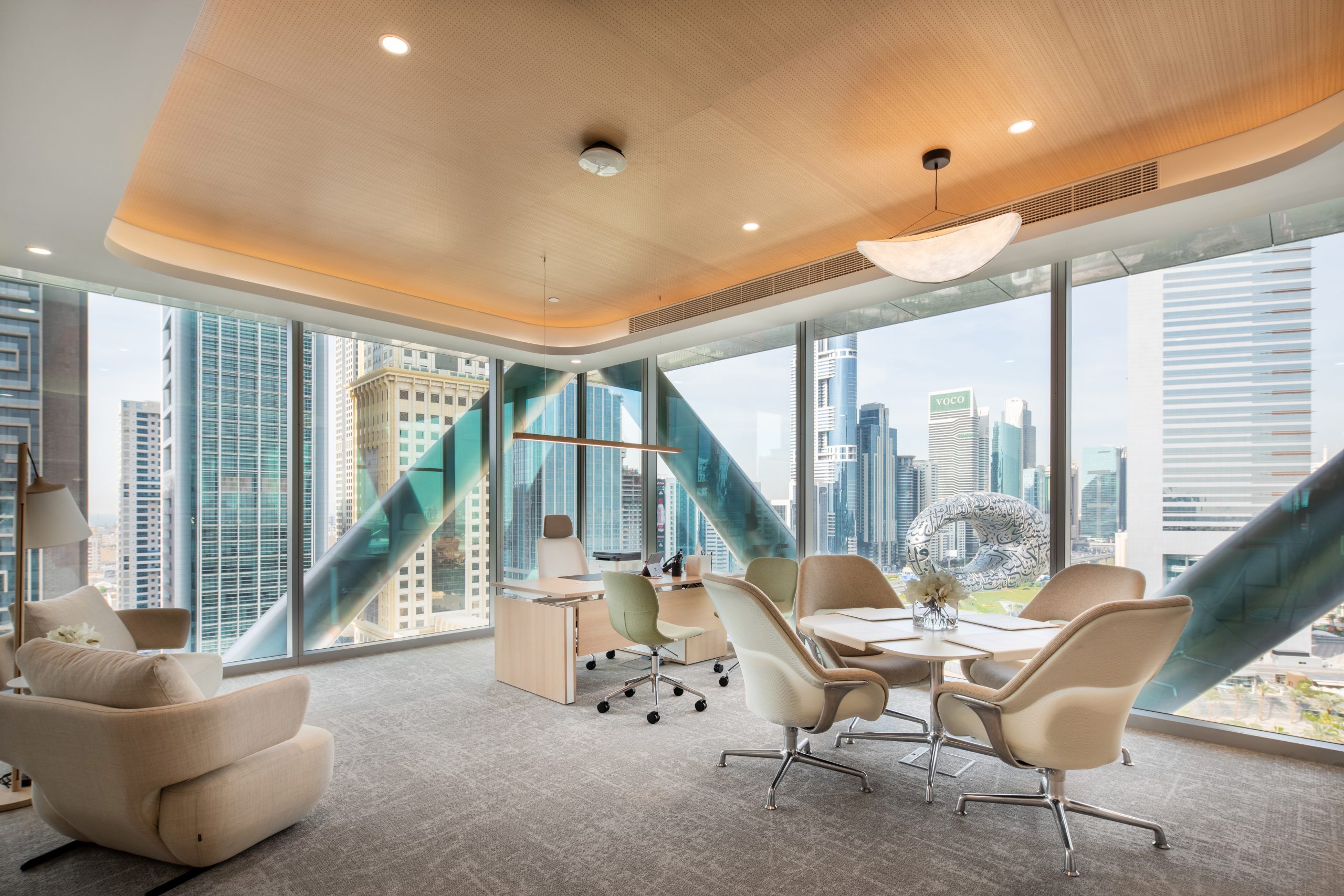 A room with a large window and a table and chairs 