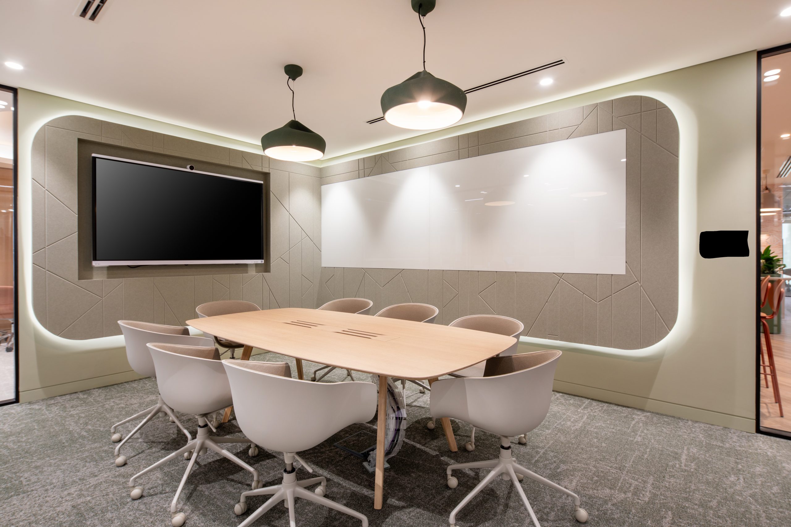 a conference room with table, chairs and a tv to display presentations