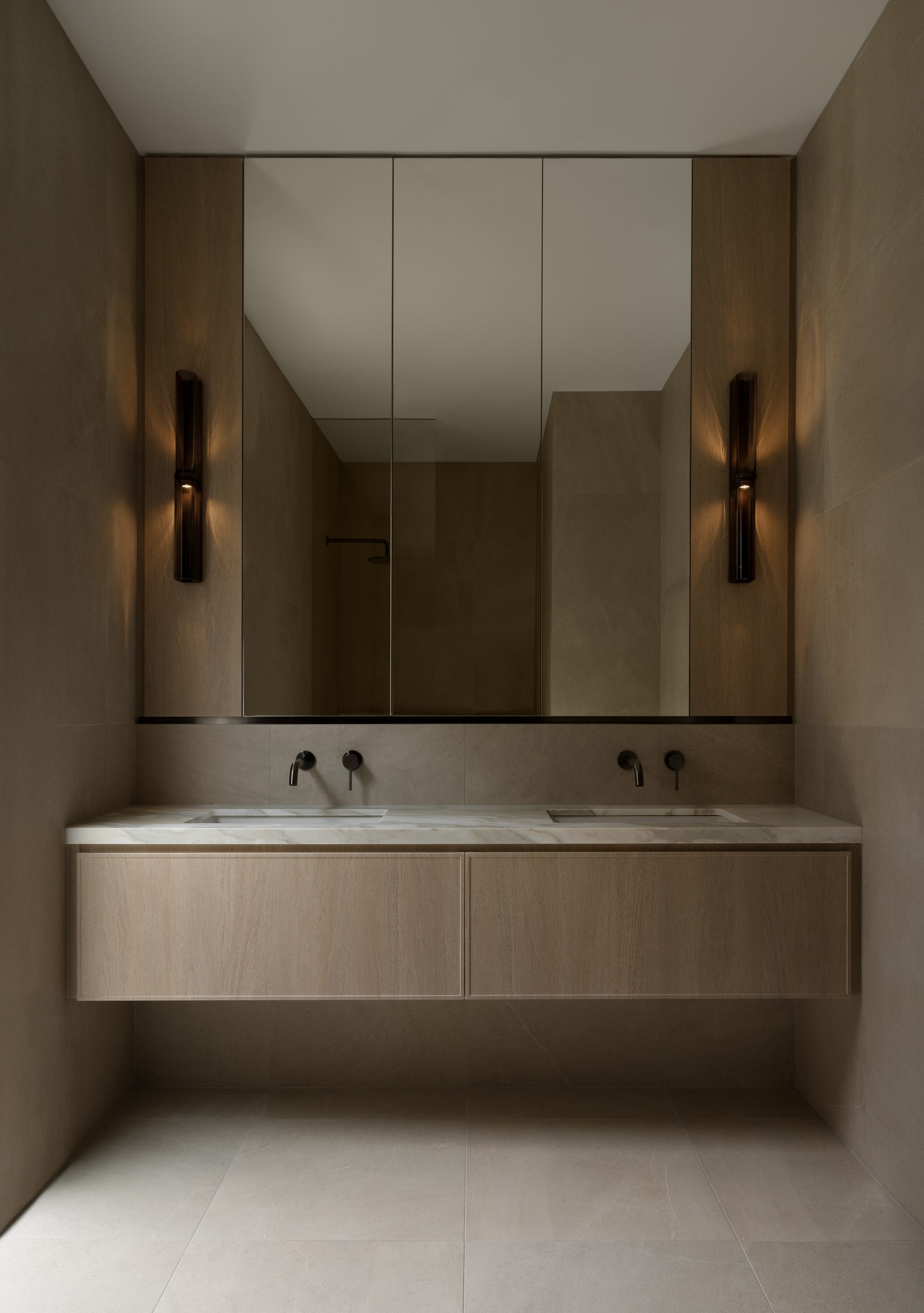 A bathroom sink with minimalist design, wood and marble finishings