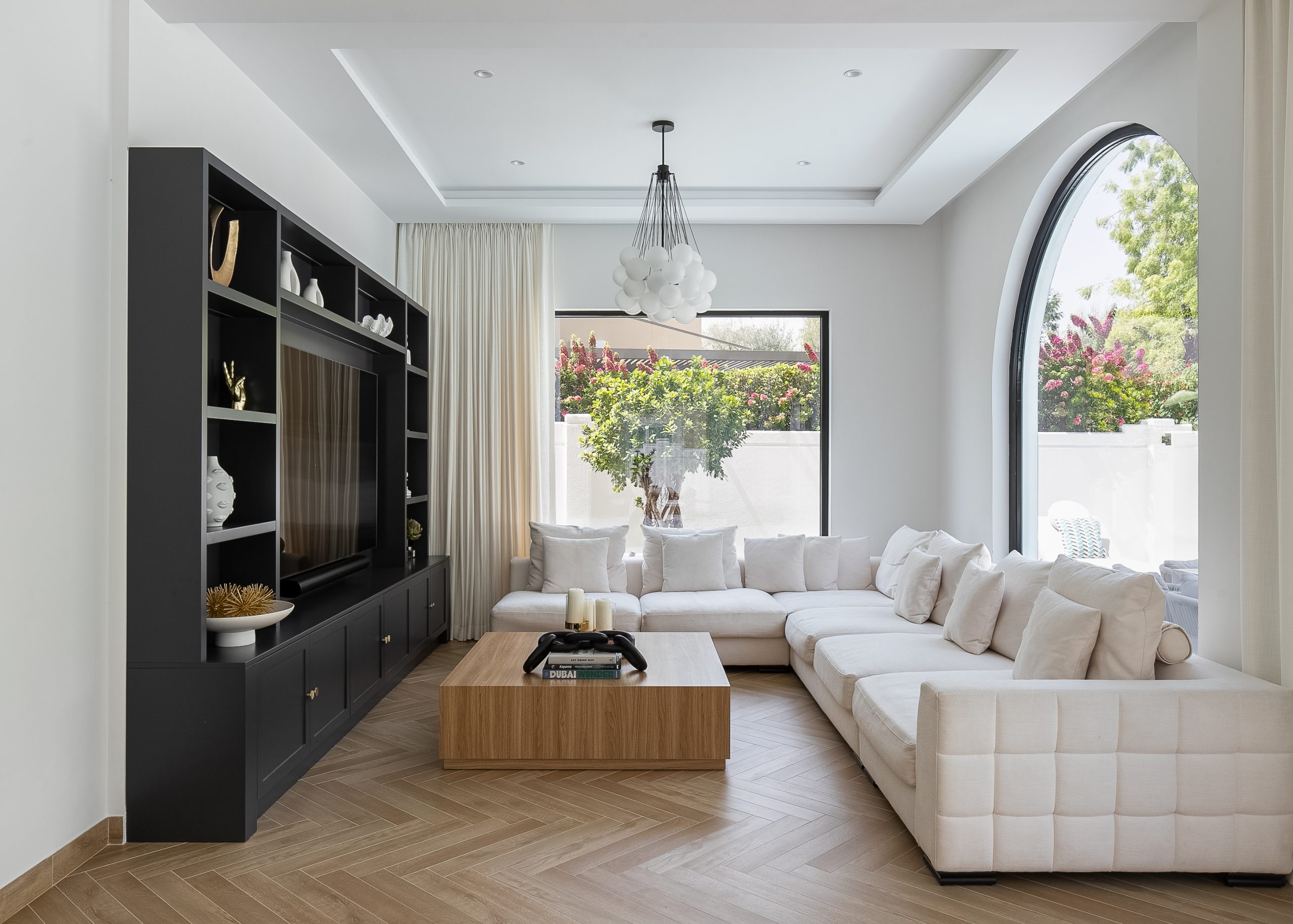 the living room with a white couch and wooden center piece 