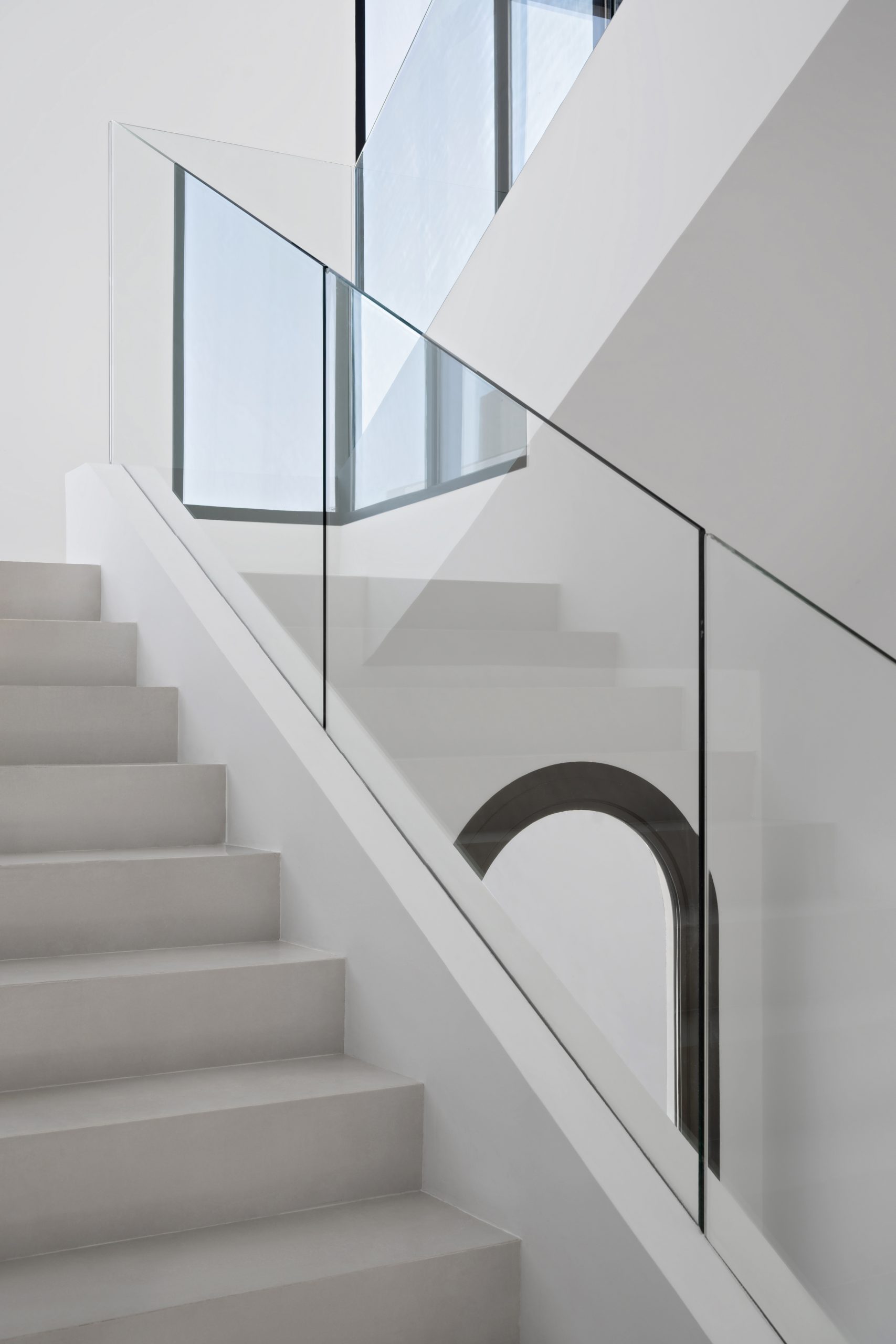 White staircase with glass railings