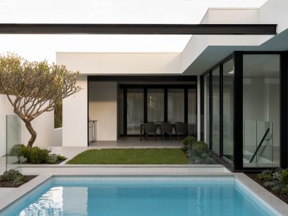 exteriors of the woodland home, seamless integration of outdoor pool with indoor spaces