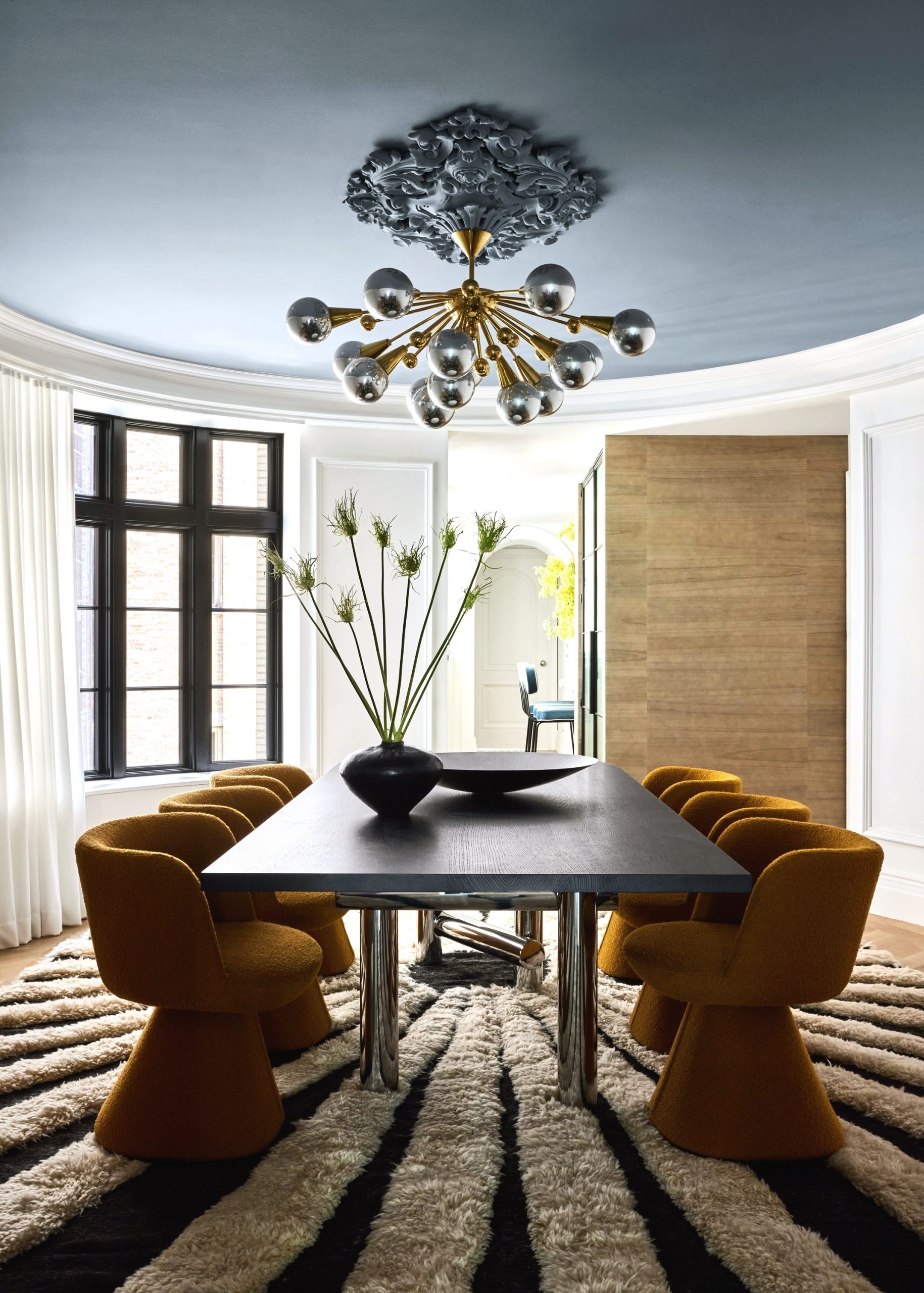 A dining room with a chandelier and a table