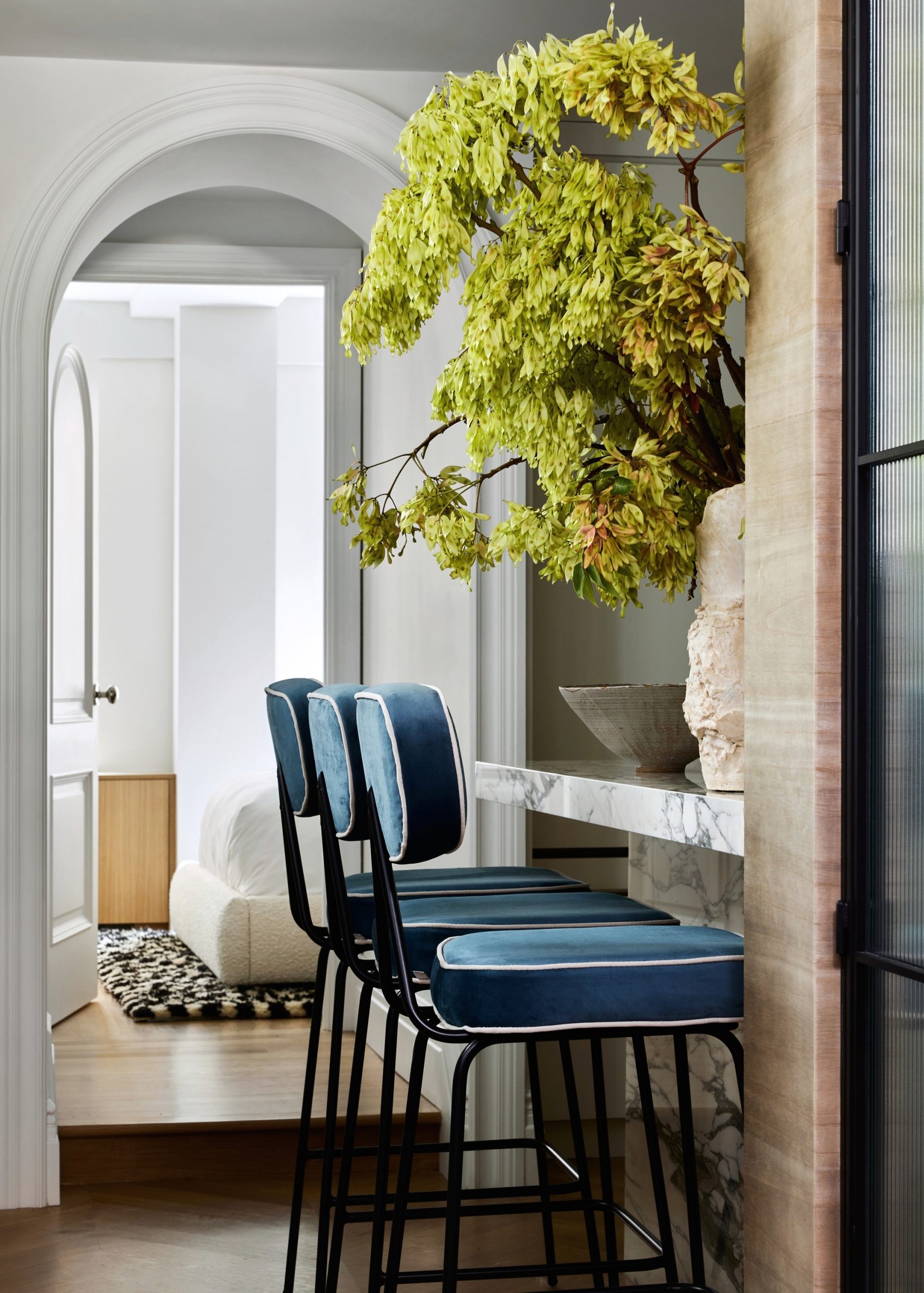 blue chairs against the kitchen island