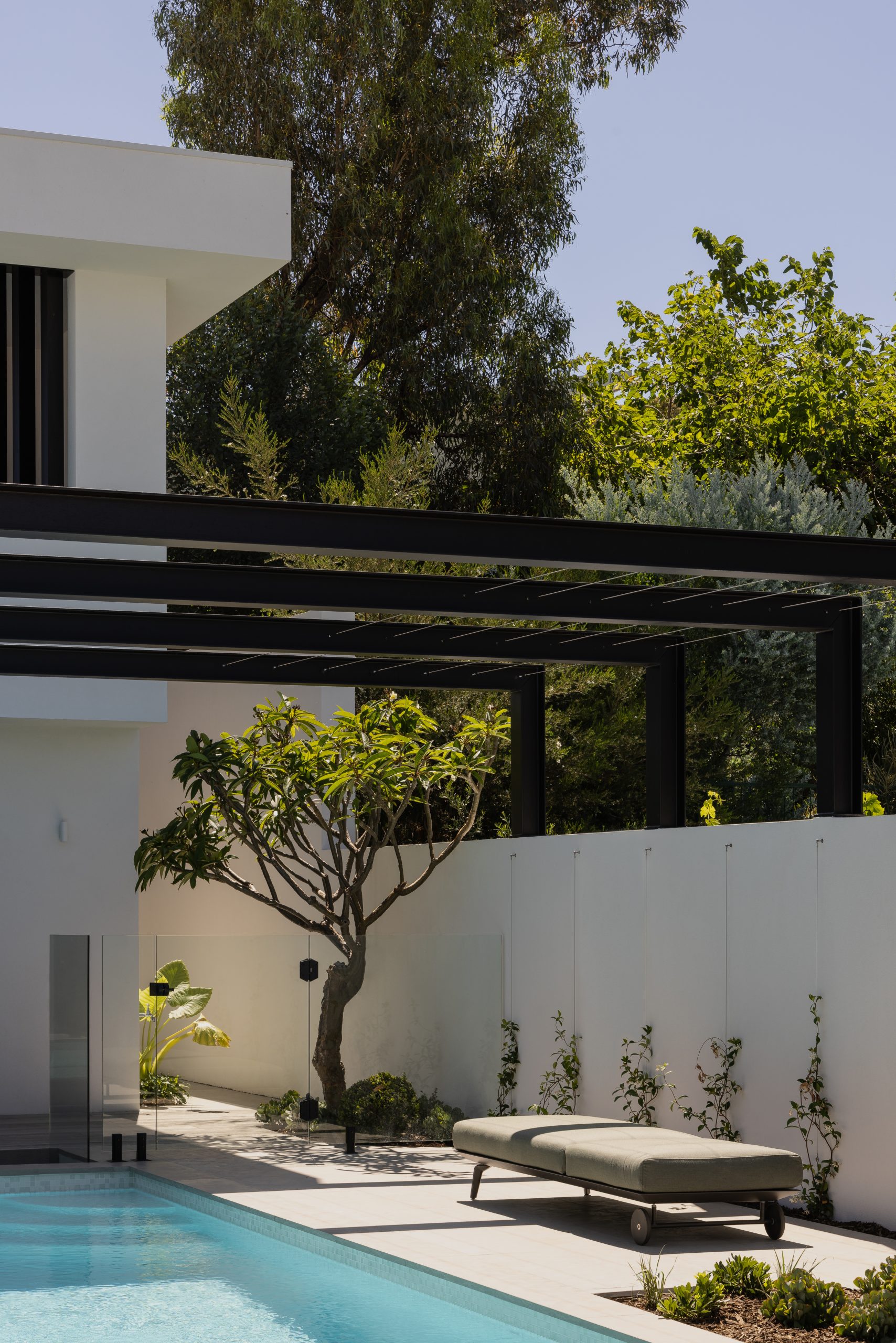 exteriors of the home showcasing the pool with the upstairs balcony