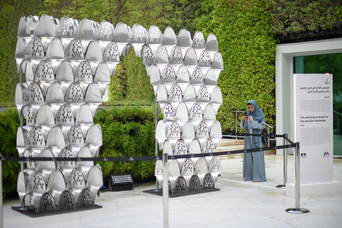 A person standing in front of a sculpture