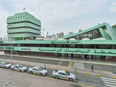 A green building with cars parked on the side for Biennial